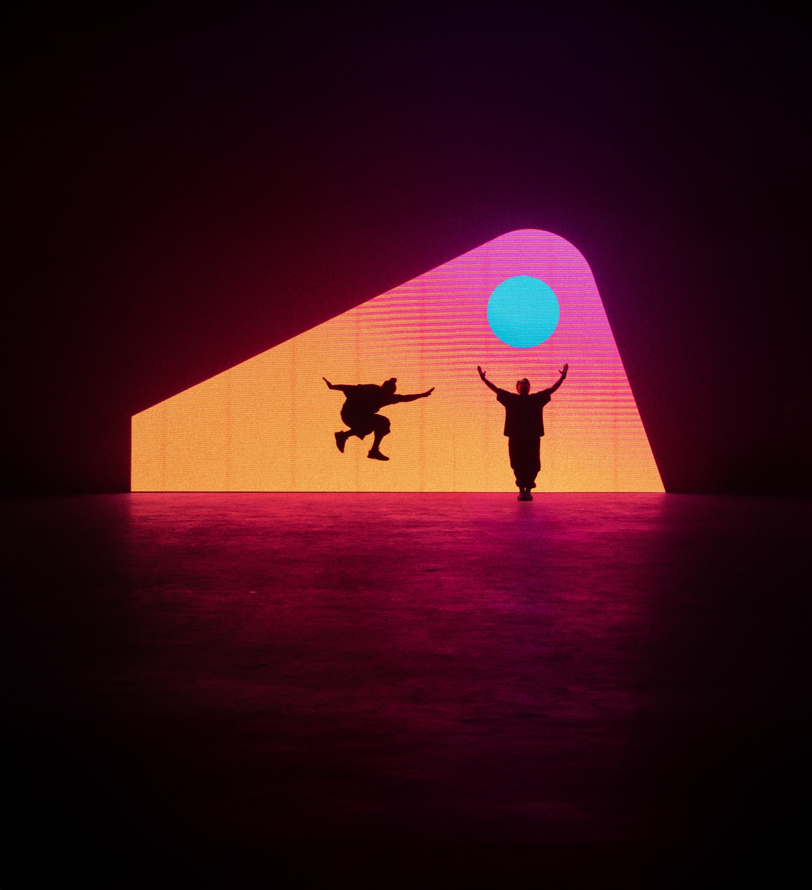 Tritonal jumping and posing against a bright geometric stage visual